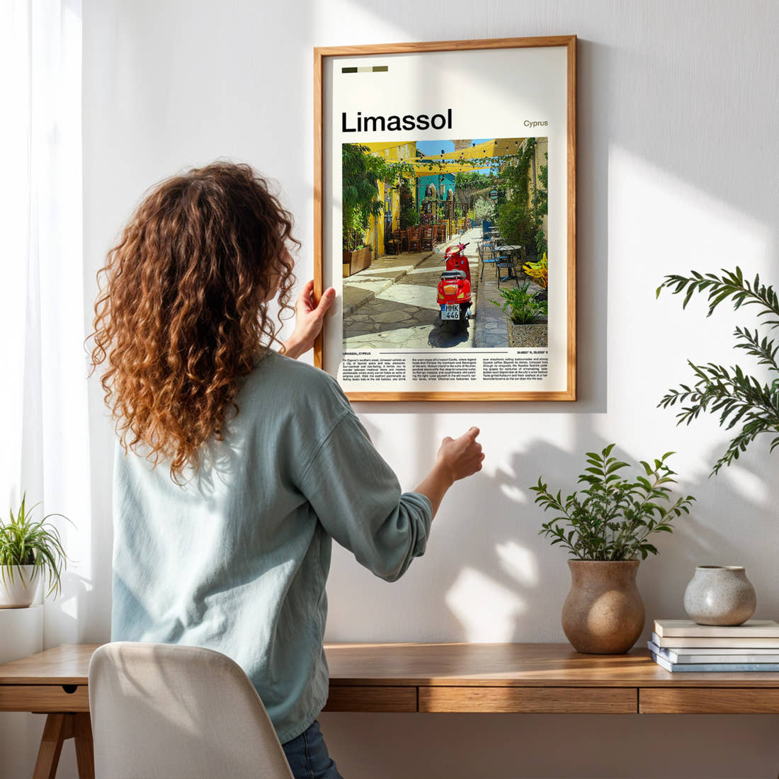 Limassol Old Town Alleyway Travel Print framed on a pale wall beside houseplants