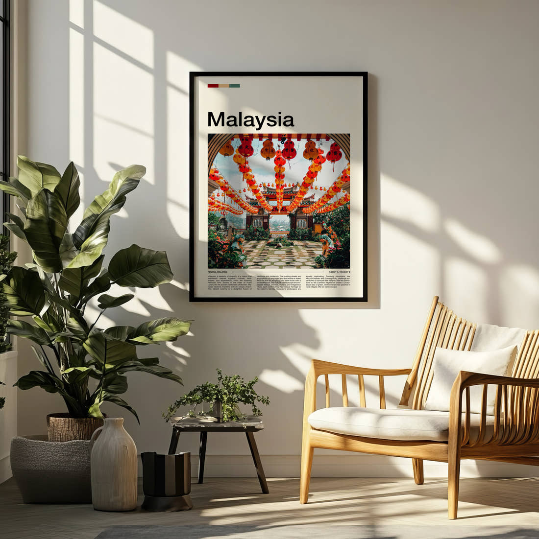 Malaysia Red Lanterns Travel Print framed on a pale wall beside houseplants