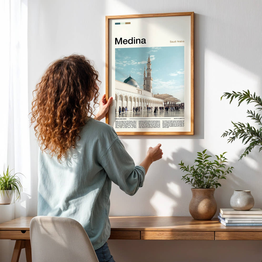 Medina Mosque Courtyard View Travel Print framed on a pale wall beside houseplants