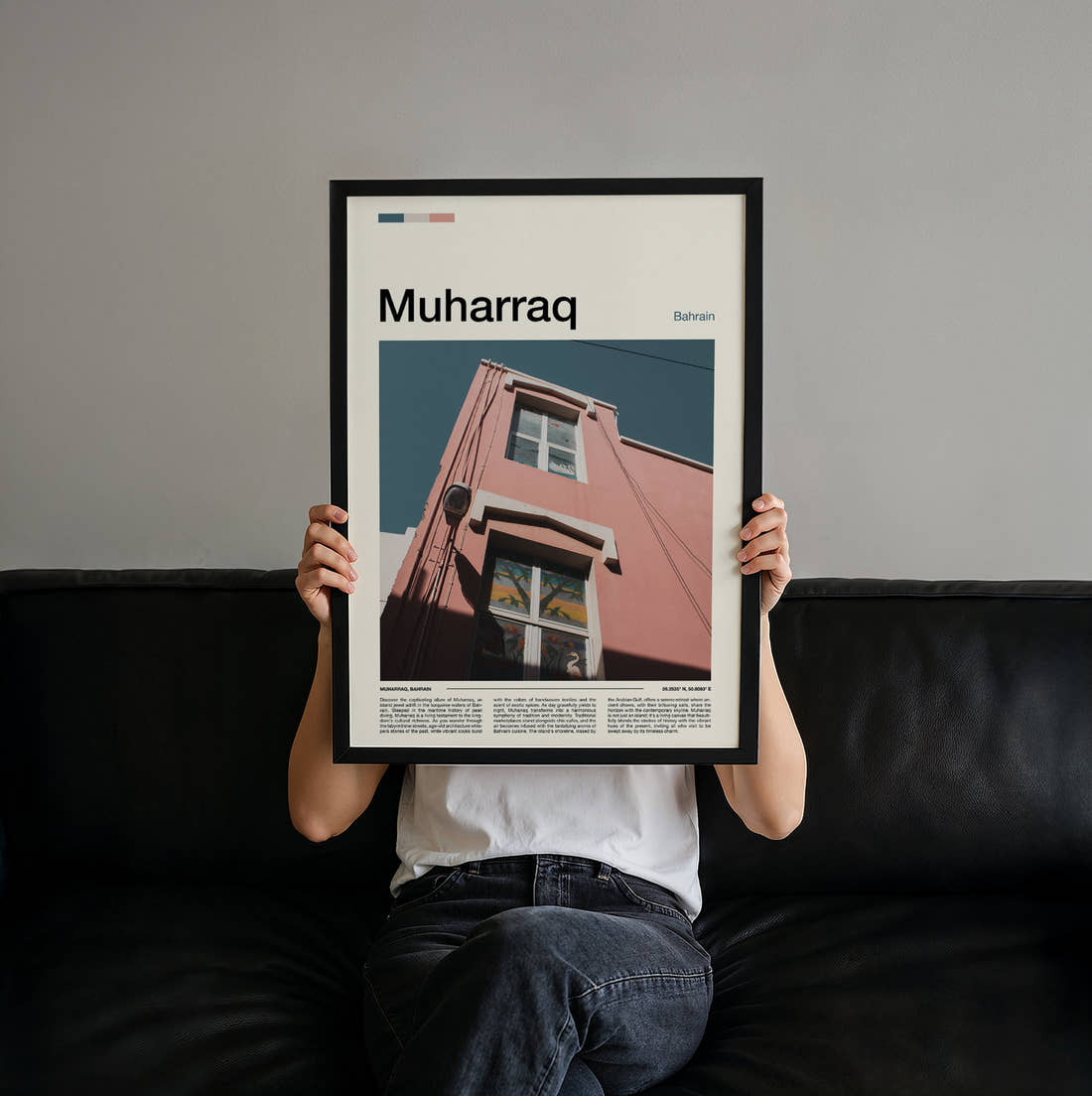 Muharraq Pink Building Corner Travel Print held up by hand to show the size of the print