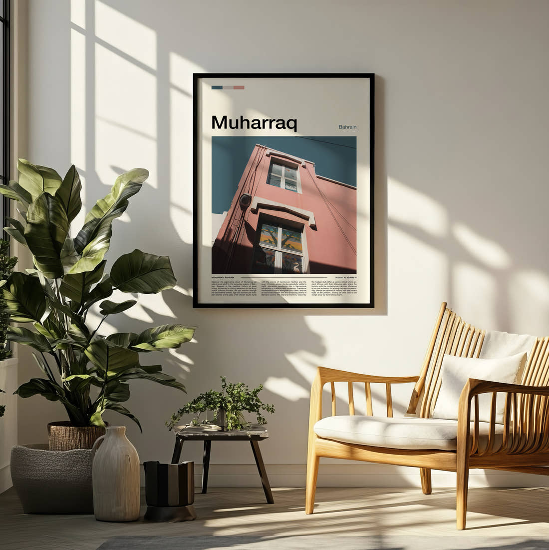 Muharraq Pink Building Corner Travel Print framed on a pale wall beside houseplants
