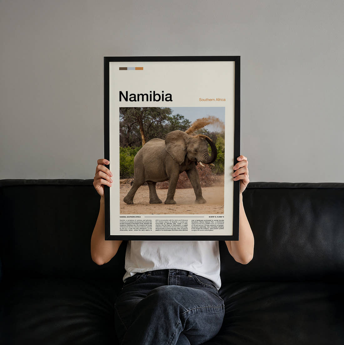 Namibia Elephant Dusting Itself Travel Print held up by hand to show the size of the print