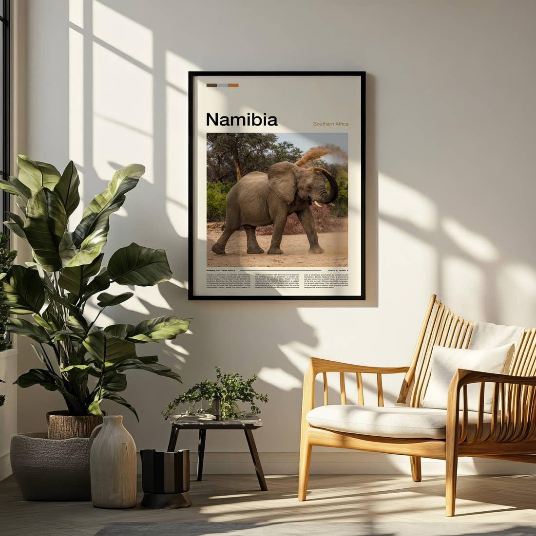 Namibia Elephant Dusting Itself Travel Print framed on a pale wall beside houseplants