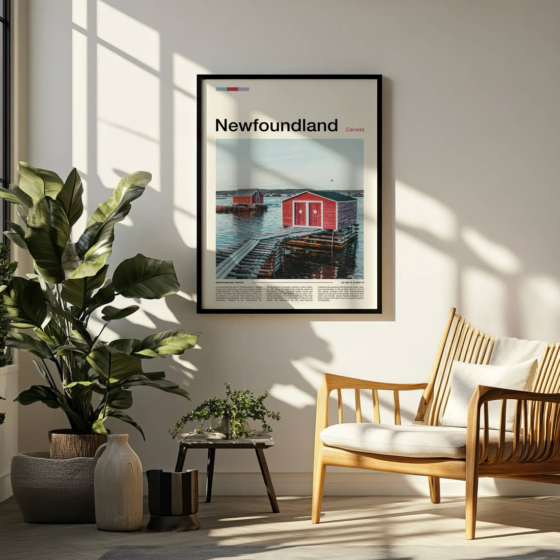 Newfoundland Red Boathouse Travel Print framed on a pale wall beside houseplants