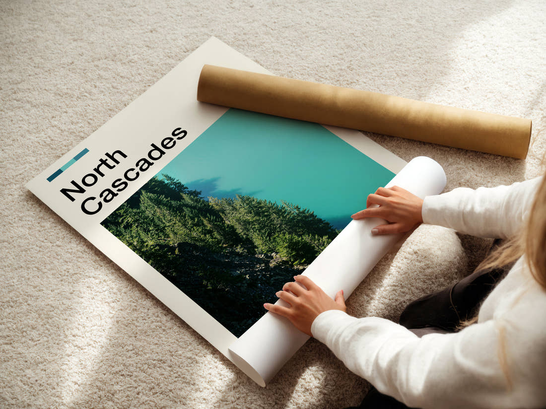 North Cascades Turquoise Lake And Forest Travel Print being unrolled from its postal tube