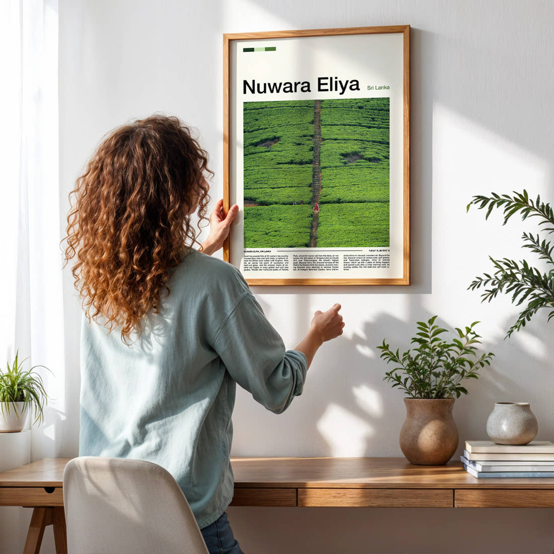 Nuwara Eliya Aerial Tea Plantation Travel Print framed on a pale wall beside houseplants