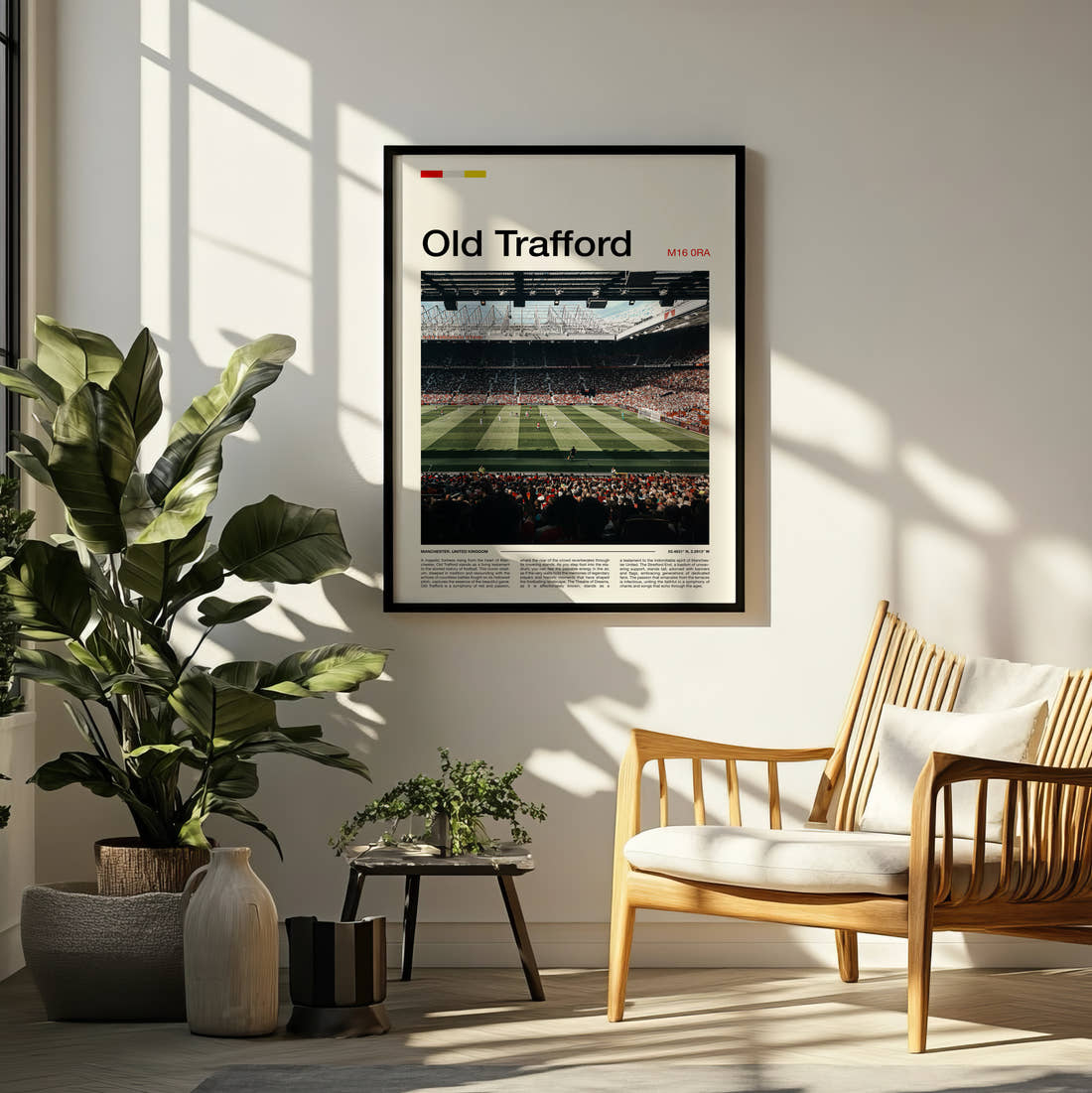 Old Trafford Stadium Print framed on a pale wall beside houseplants