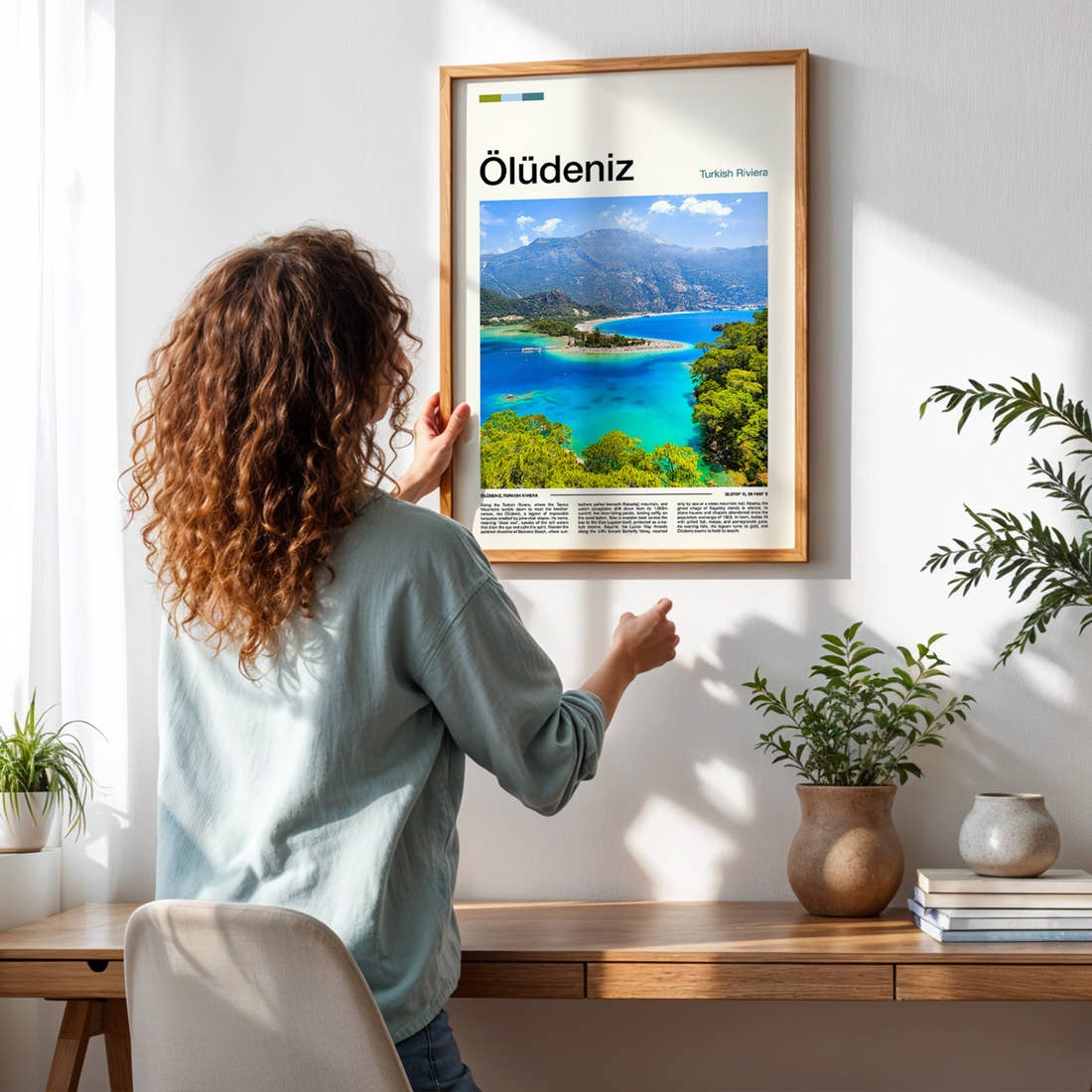 Ölüdeniz Turquoise Lagoon Aerial Travel Print framed on a pale wall beside houseplants