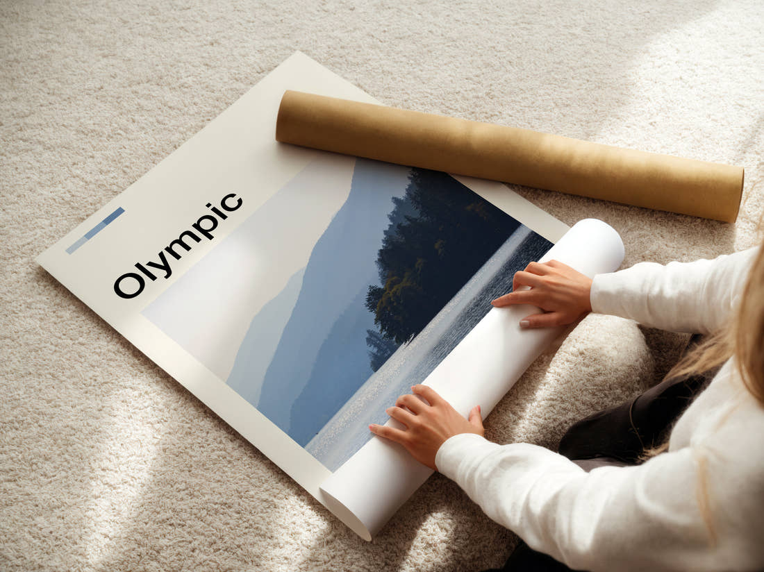 Olympic Misty Lake And Hills Travel Print being unrolled from its postal tube