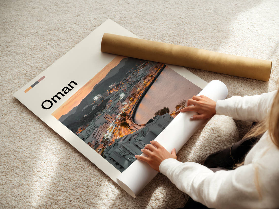 Oman Waterfront Buildings And Bay Travel Print being unrolled from its postal tube