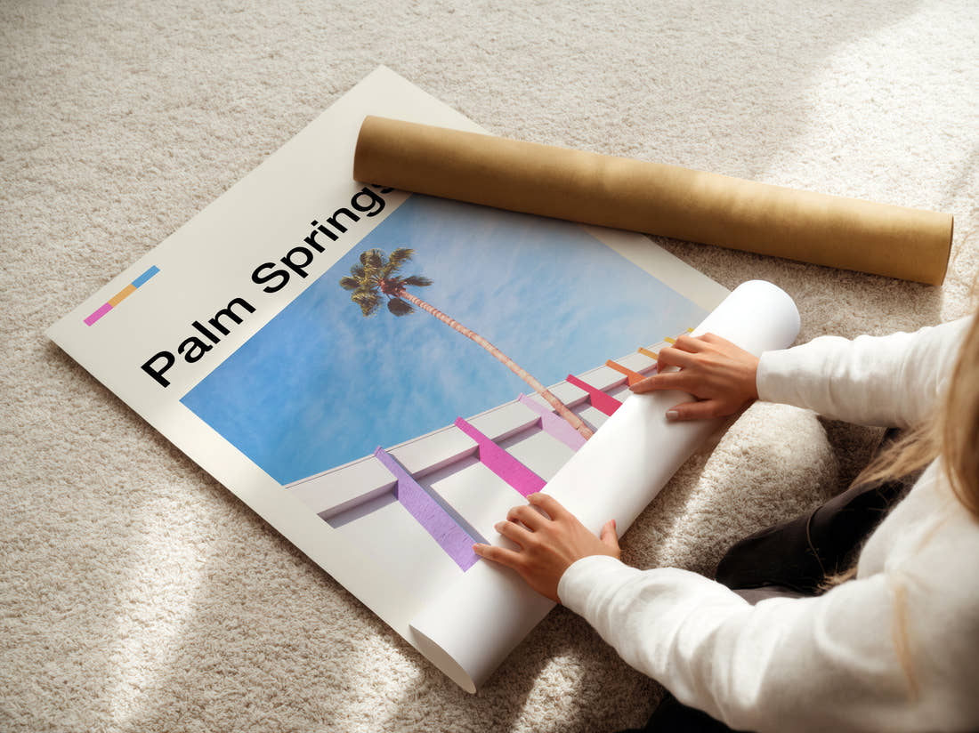 Palm Springs Palm Tree And Pink Wall Travel Print being unrolled from its postal tube