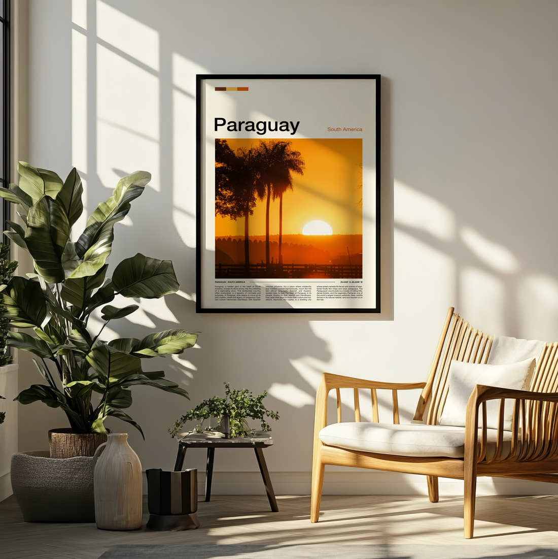 Paraguay Sunset Through Palm Trees Travel Print framed on a pale wall beside houseplants