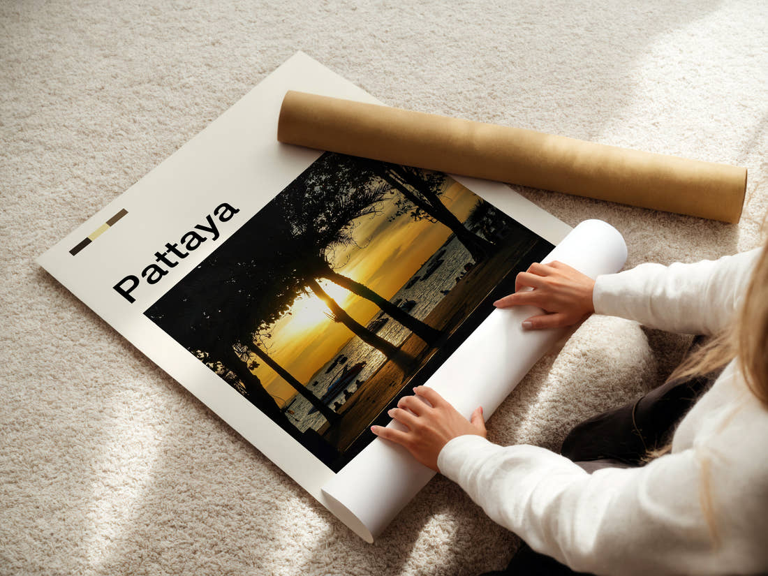 Pattaya Palm-Framed Sunset Travel Print being unrolled from its postal tube