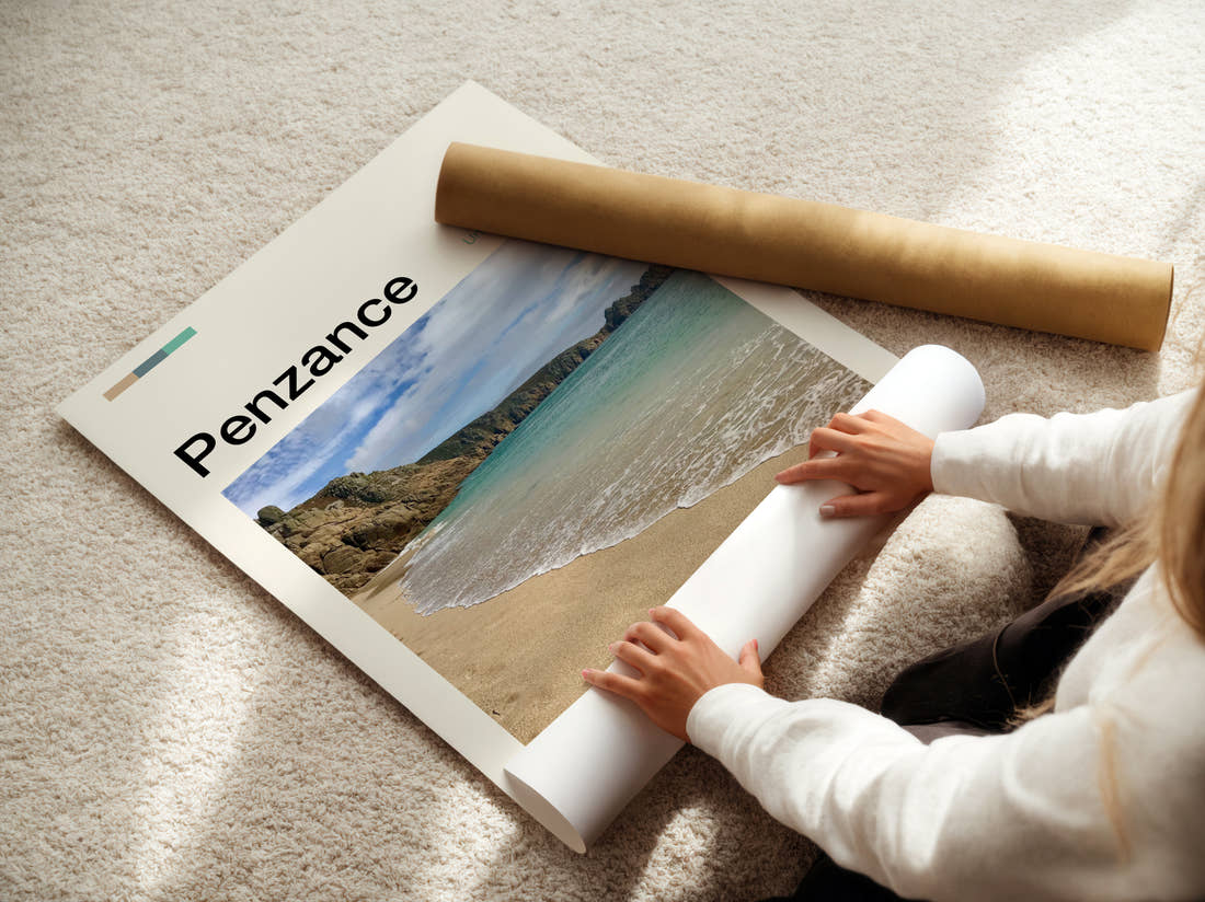 Penzance Beach And Cliffs Travel Print being unrolled from its postal tube