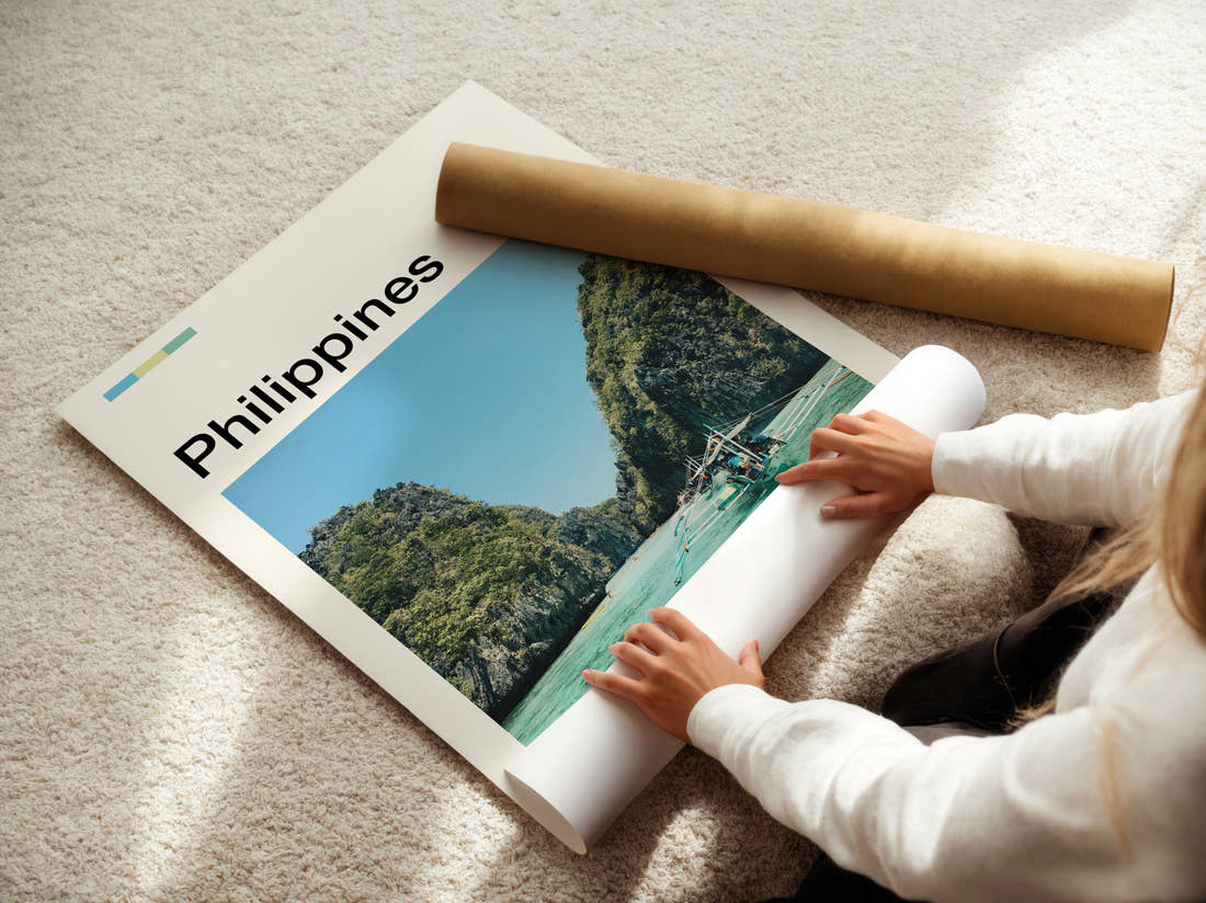 Philippines Outrigger Boat And Cliffs Travel Print being unrolled from its postal tube