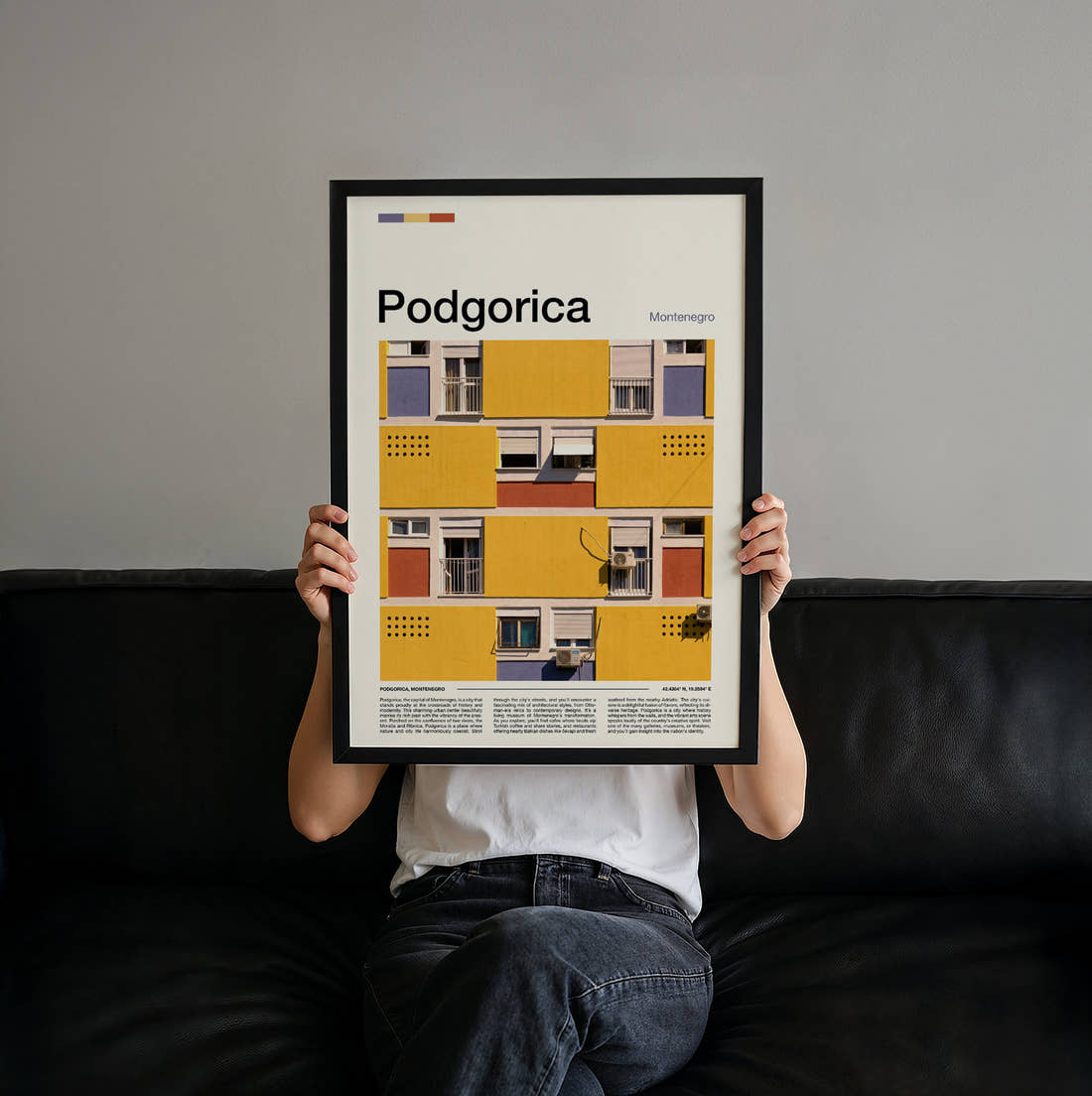 Podgorica Colourful Building Facade Travel Print held up by hand to show the size of the print