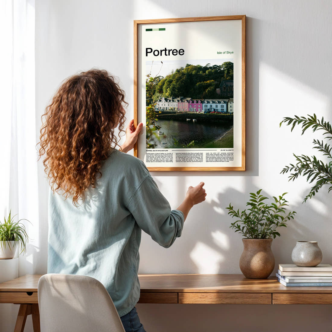 Portree Colourful Harbour Row Travel Print framed on a pale wall beside houseplants