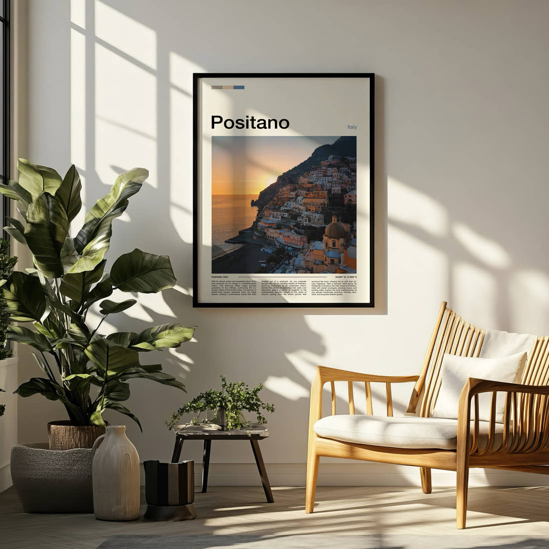 Positano Cliffside Town At Sunset Travel Print framed on a pale wall beside houseplants