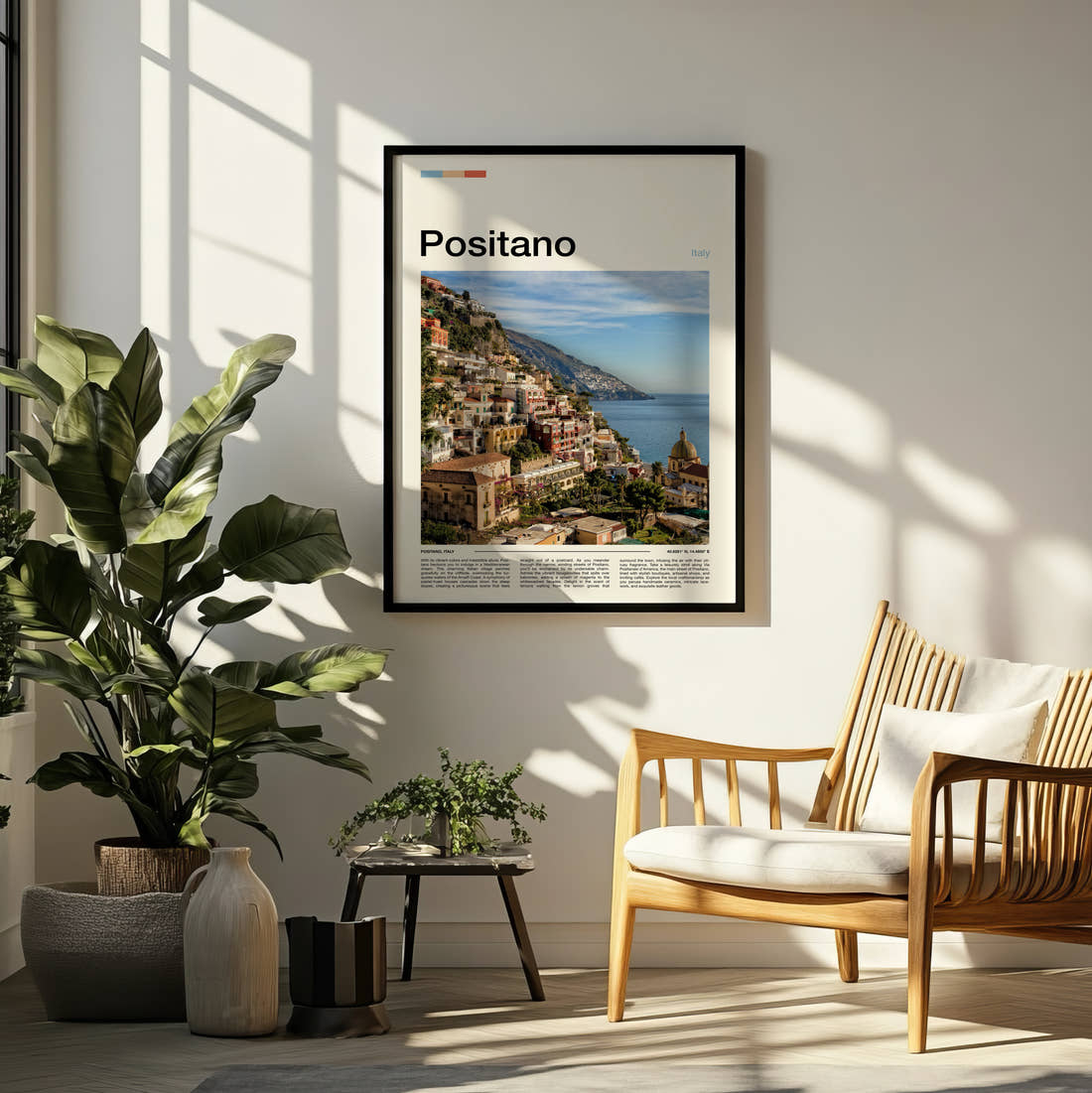 Positano Hillside Town And Sea Travel Print framed on a pale wall beside houseplants