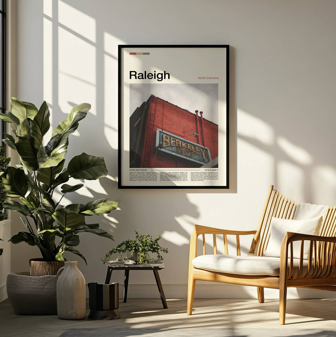 Raleigh Brick Building With Sign Travel Print framed on a pale wall beside houseplants