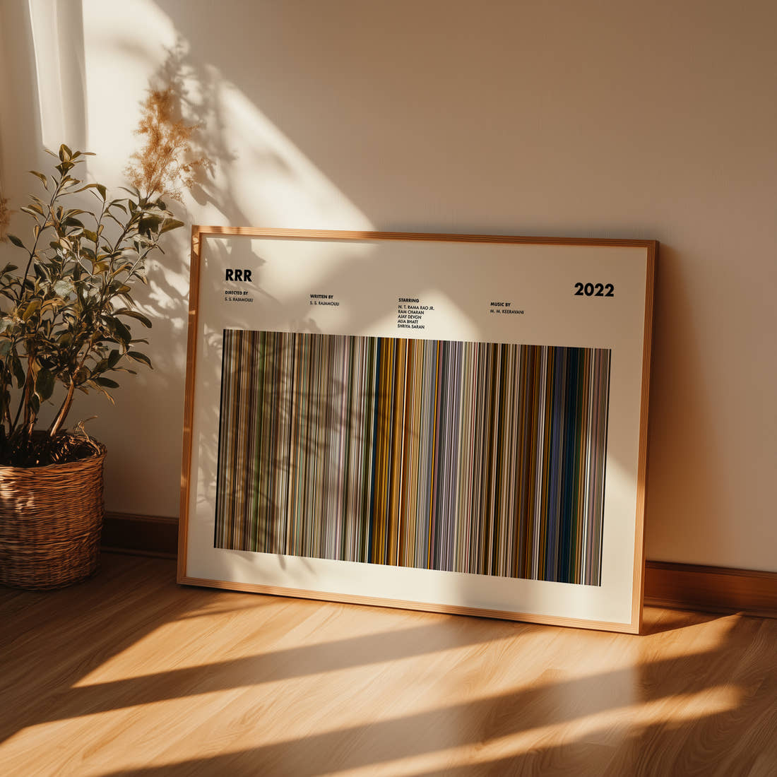 RRR Movie Barcode Poster framed and leaning against a wall on a wooden floor