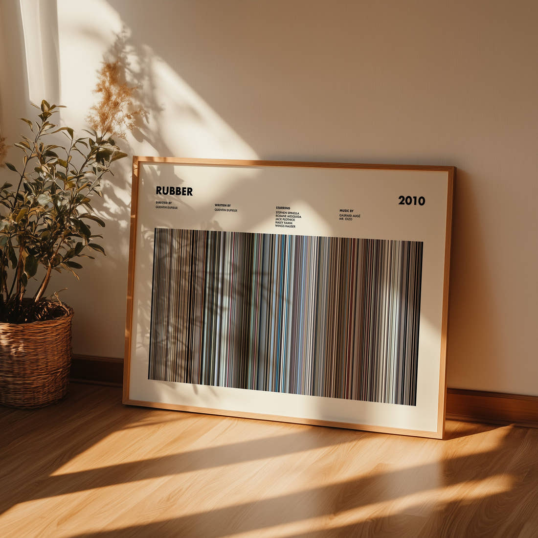 Rubber Movie Barcode Poster framed and leaning against a wall on a wooden floor