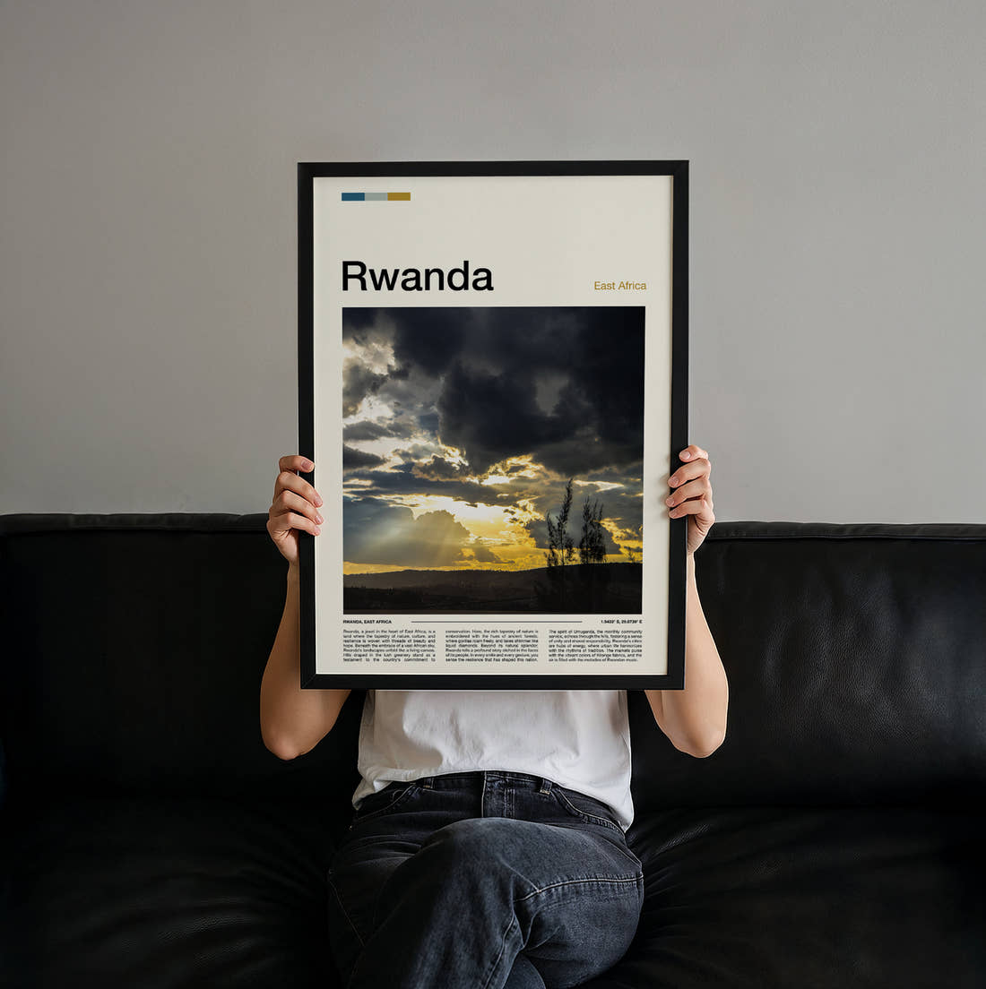 Rwanda Sunbeams Through Clouds Travel Print held up by hand to show the size of the print