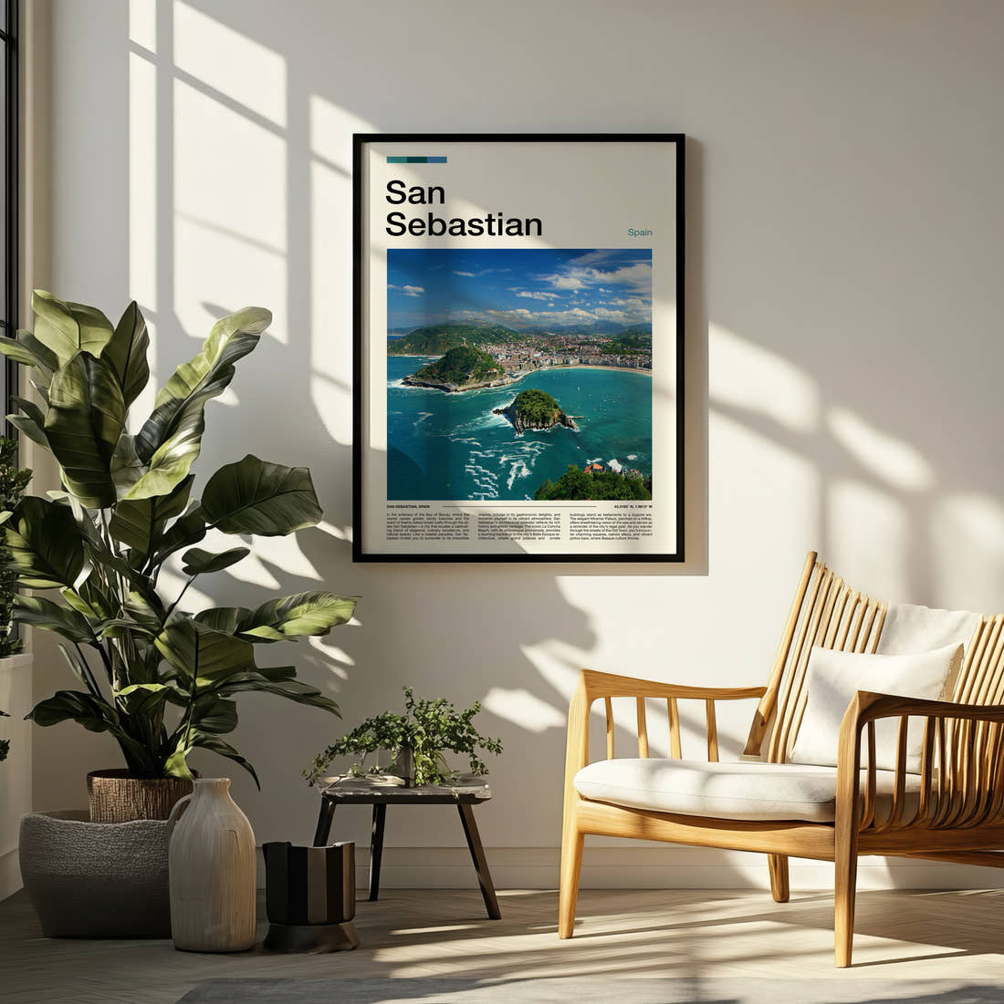 San Sebastian La Concha Bay Travel Print framed on a pale wall beside houseplants