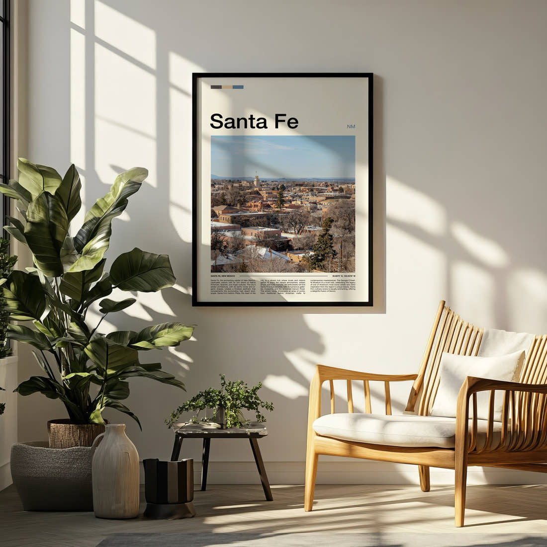 Santa Fe Adobe Townscape Travel Print framed on a pale wall beside houseplants