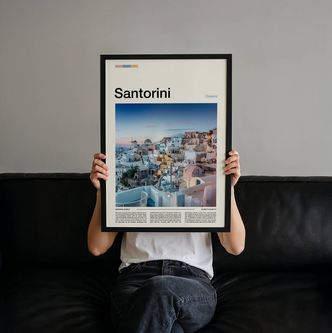 Santorini Clifftop Village At Sunset Travel Print held up by hand to show the size of the print
