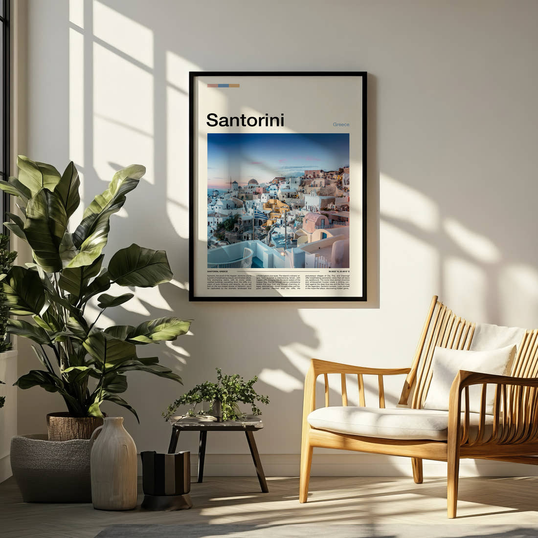 Santorini Clifftop Village At Sunset Travel Print framed on a pale wall beside houseplants
