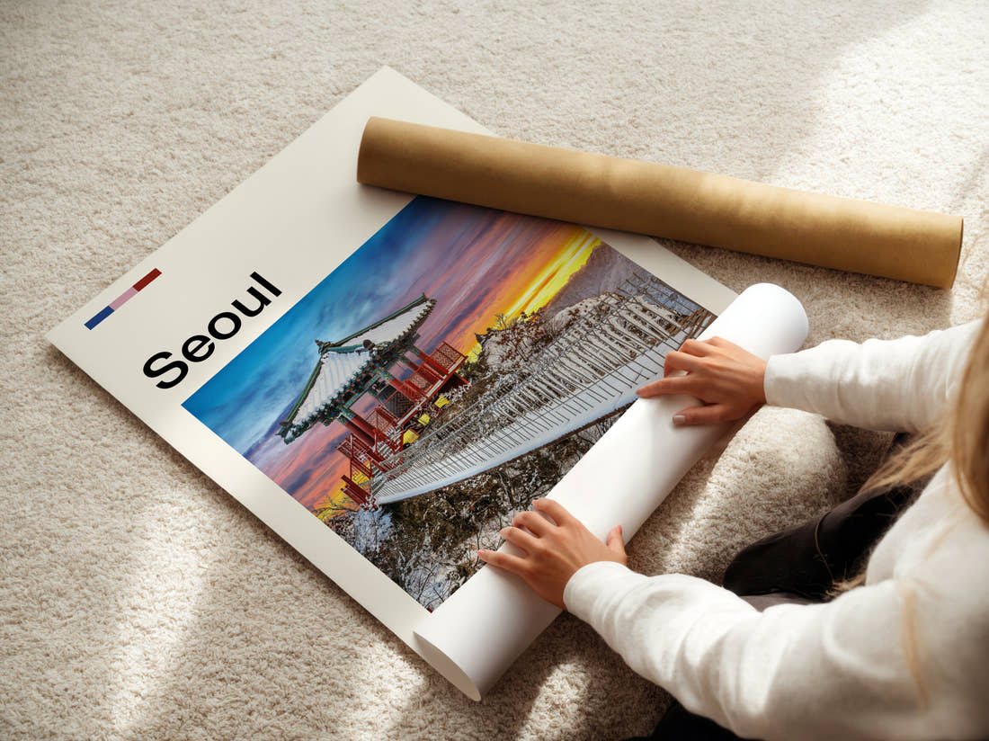 Seoul Traditional Pavilion In Snow Travel Print being unrolled from its postal tube