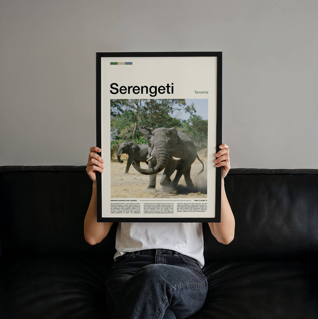 Serengeti Elephants Sparring Travel Print held up by hand to show the size of the print