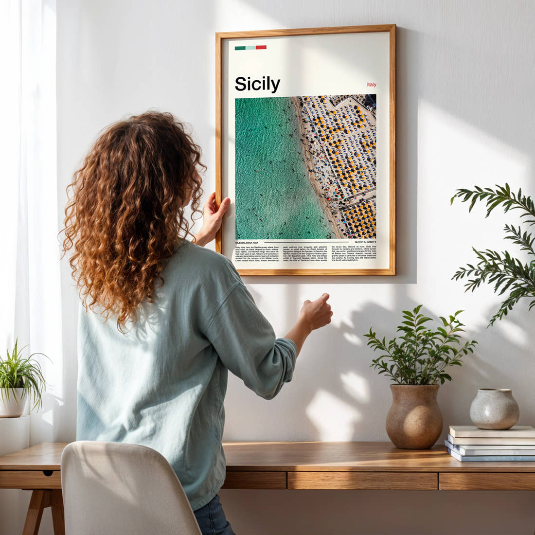 Sicily Aerial Beach View Travel Print framed on a pale wall beside houseplants