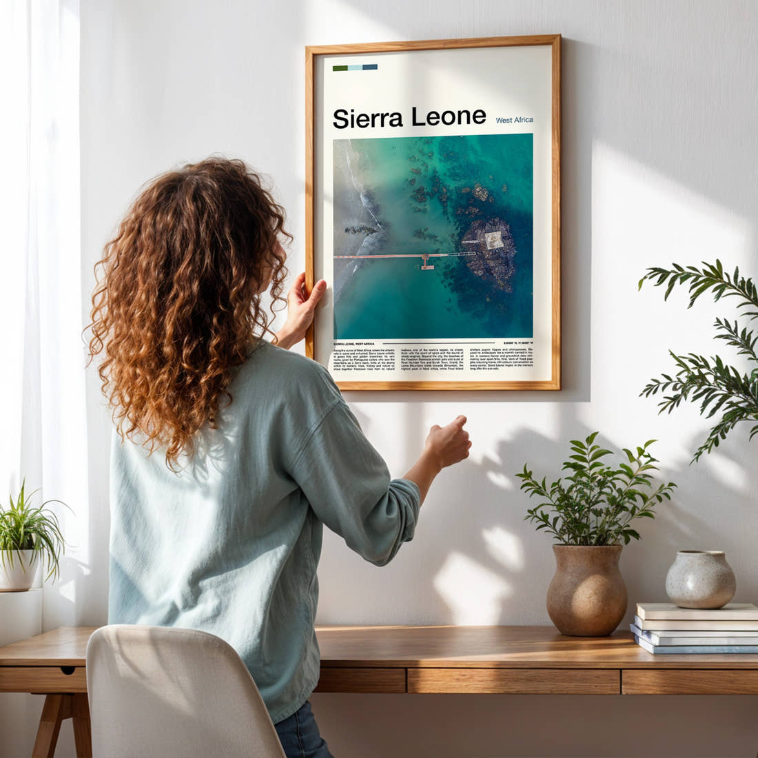 Sierra Leone Aerial Jetty View Travel Print framed on a pale wall beside houseplants