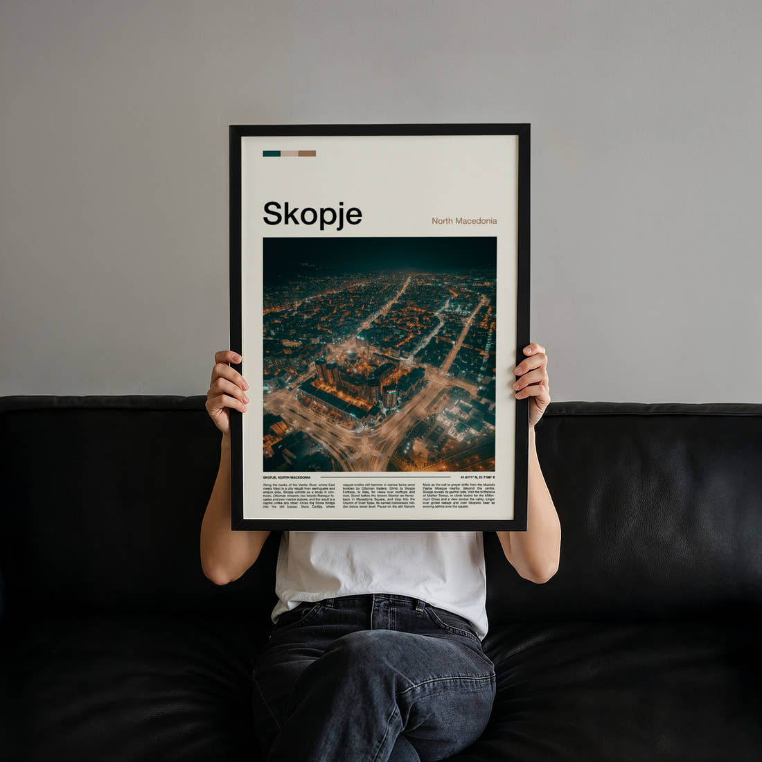 Skopje Illuminated City Sprawl Travel Print held up by hand to show the size of the print