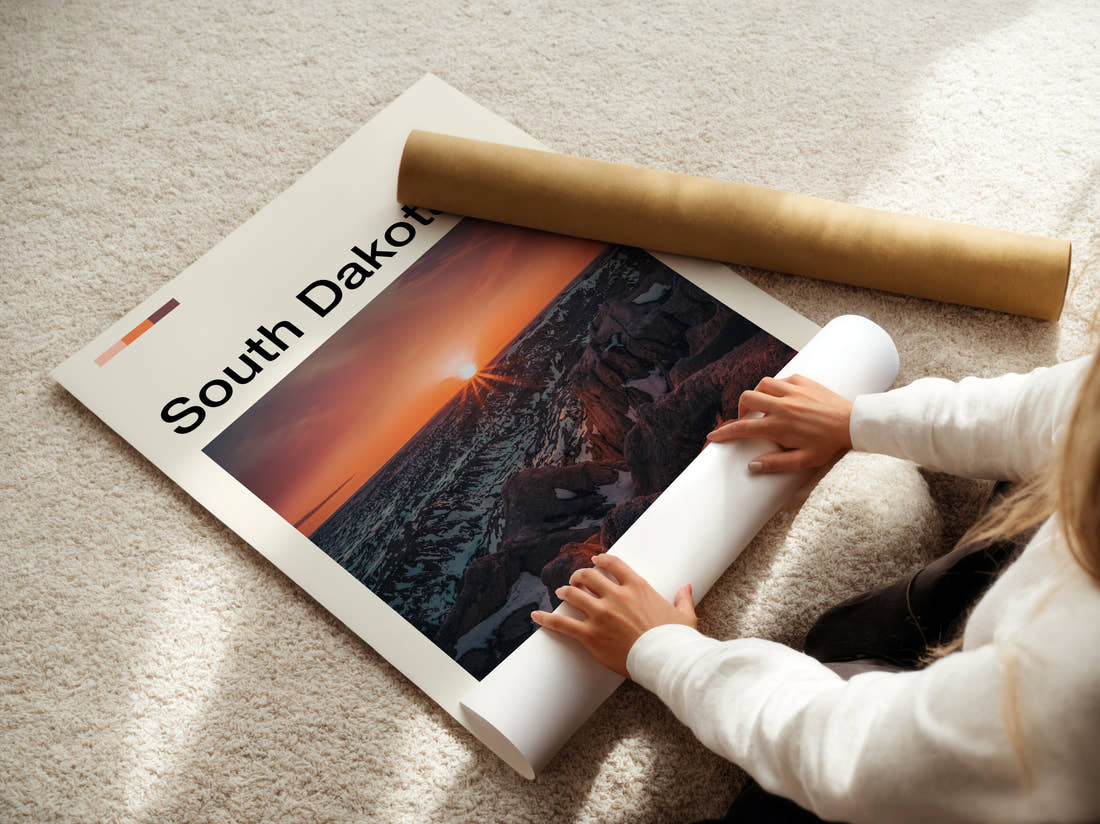 South Dakota Badlands Sunburst At Sunset Travel Print being unrolled from its postal tube