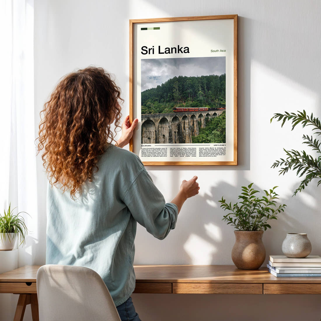 Sri Lanka Nine Arches Bridge Travel Print framed on a pale wall beside houseplants