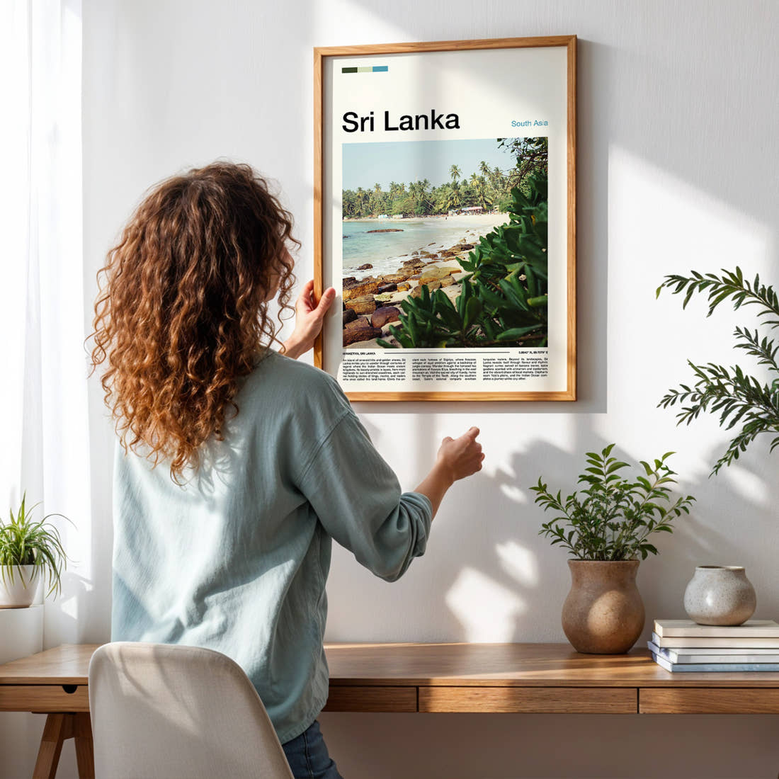 Sri Lanka Palm-Fringed Beach Travel Print framed on a pale wall beside houseplants
