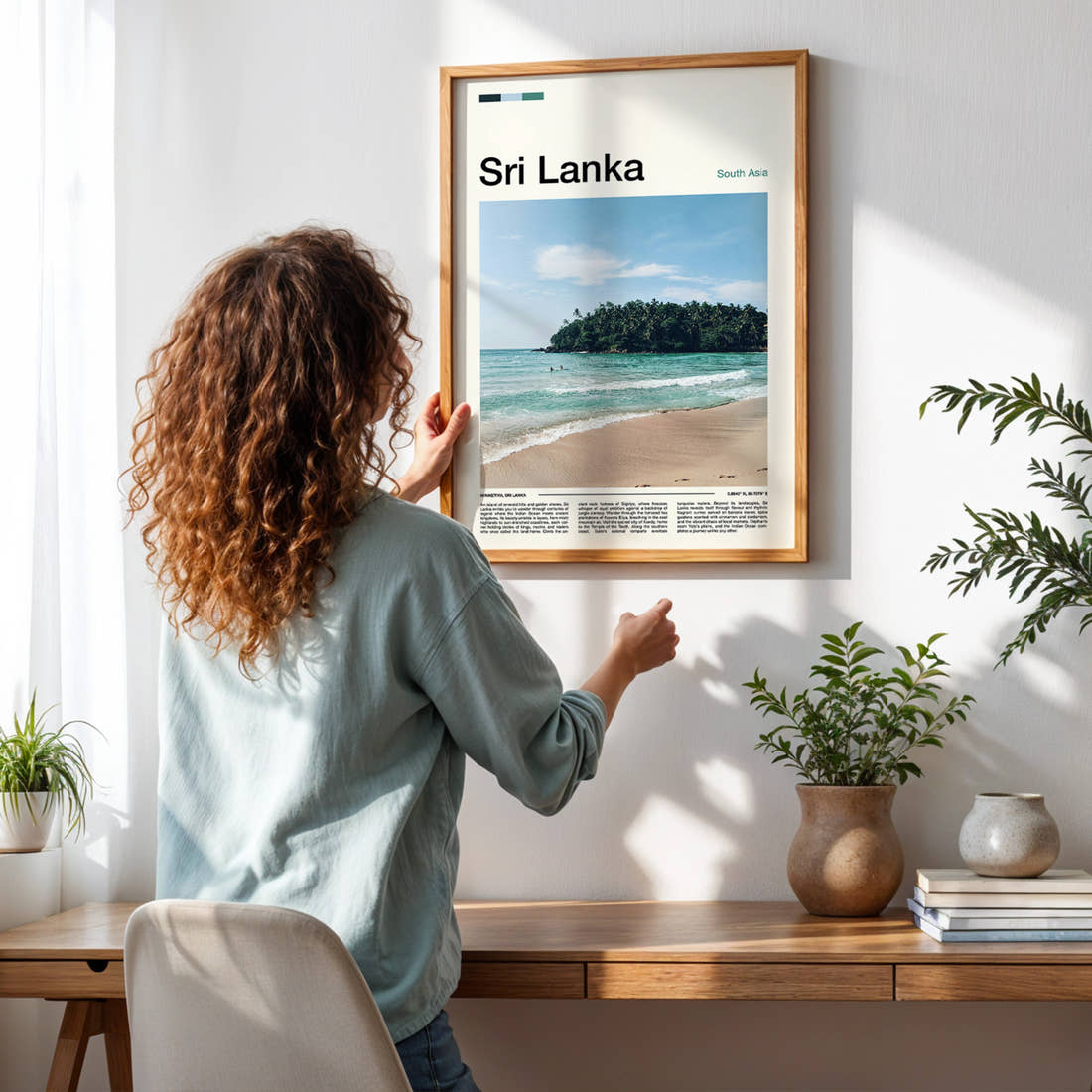 Sri Lanka Jungle Cove Shoreline Travel Print framed on a pale wall beside houseplants