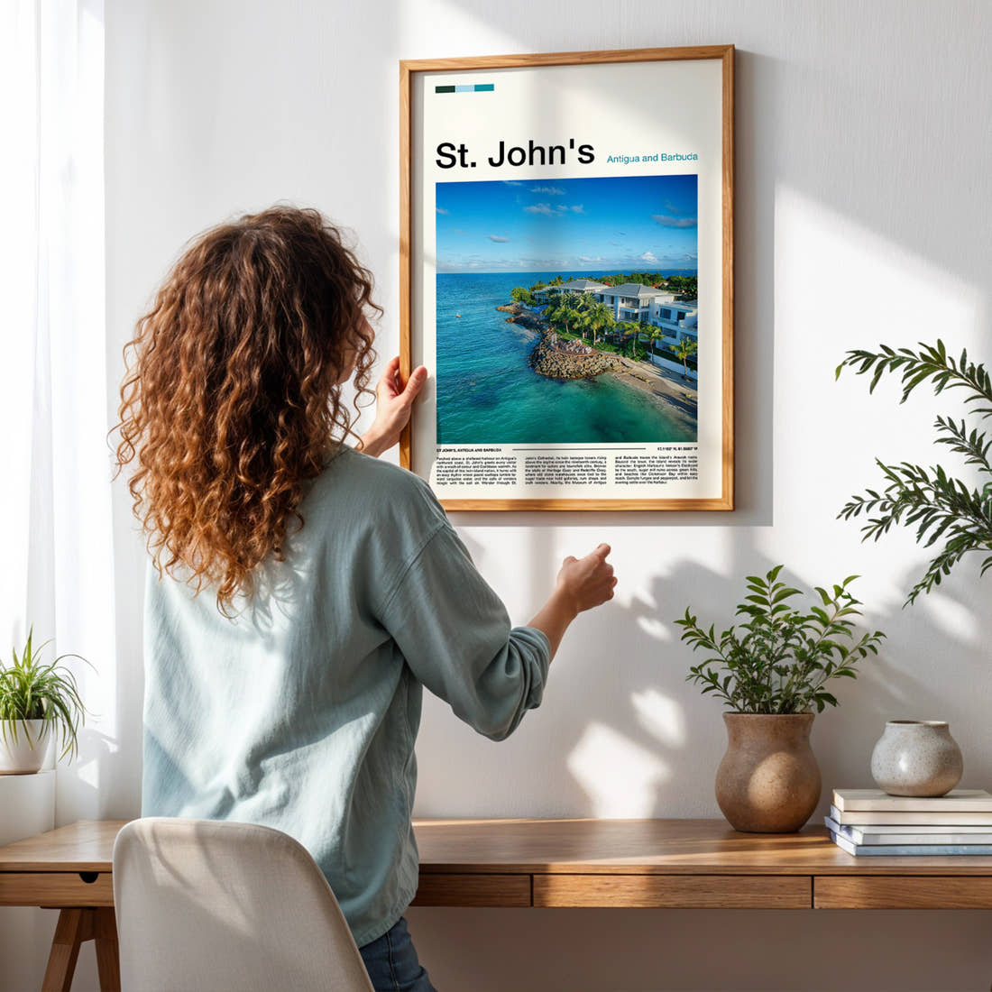 St. John's Aerial Coastal Resort Travel Print framed on a pale wall beside houseplants