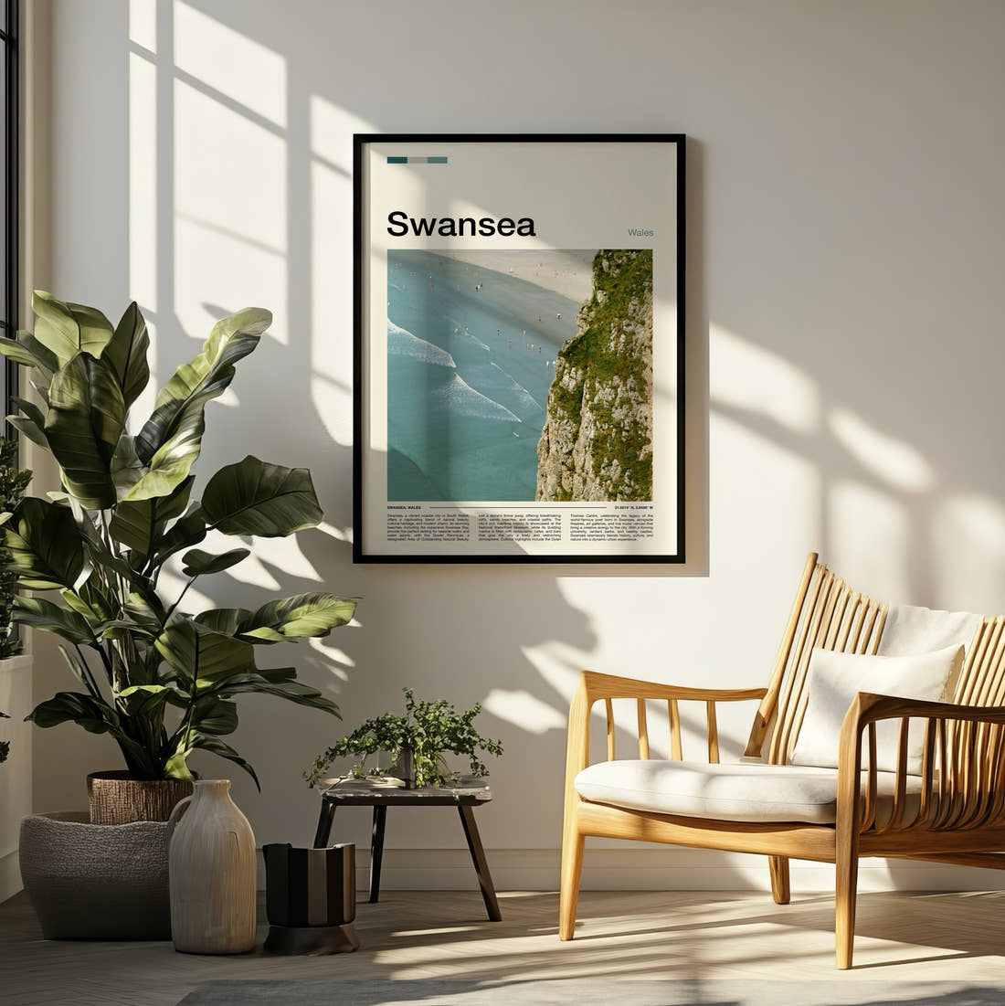 Swansea Cliff Above The Beach Travel Print framed on a pale wall beside houseplants