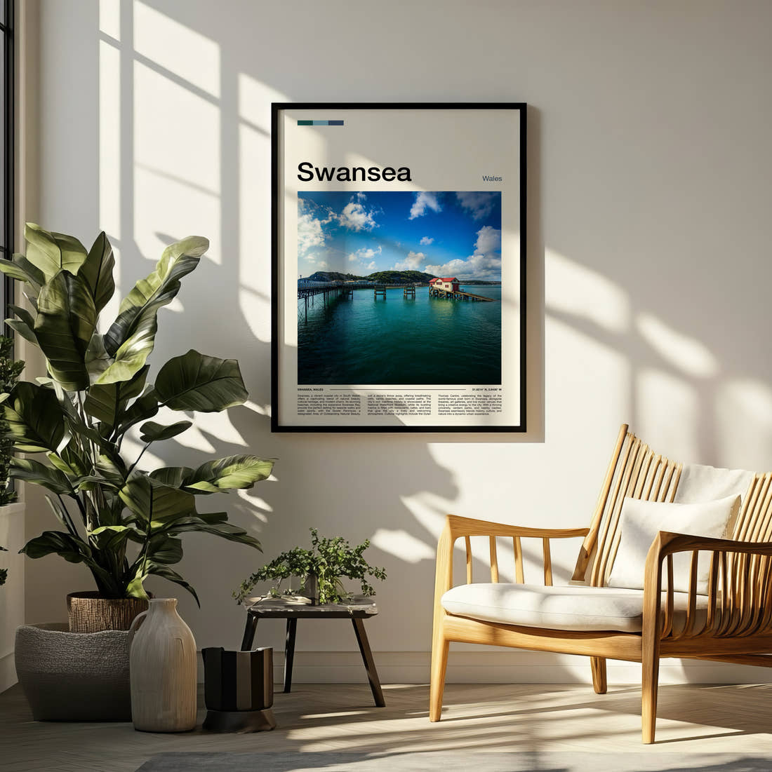 Swansea Mumbles Pier Travel Print framed on a pale wall beside houseplants