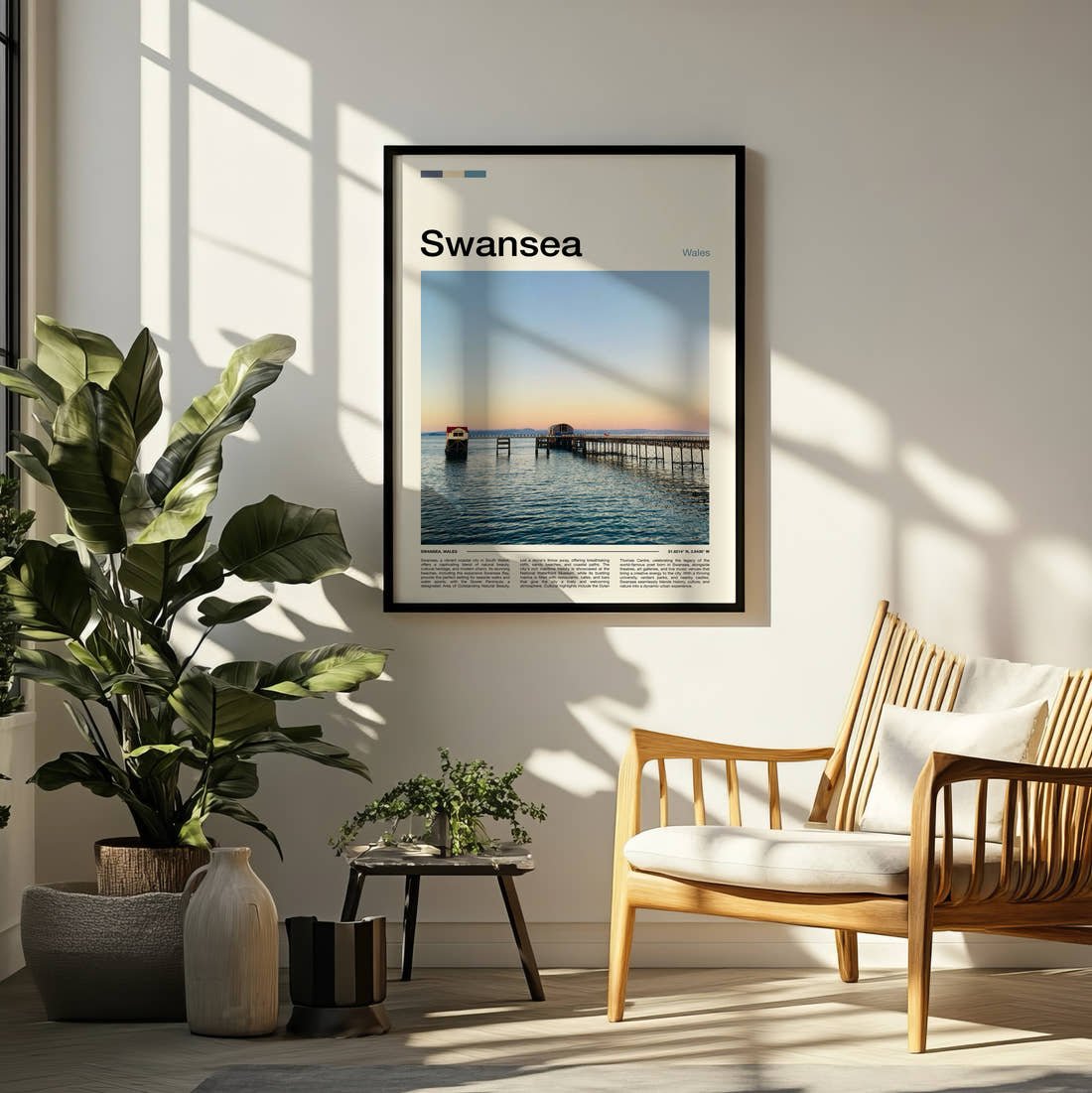 Swansea Pier At Sunset Travel Print framed on a pale wall beside houseplants