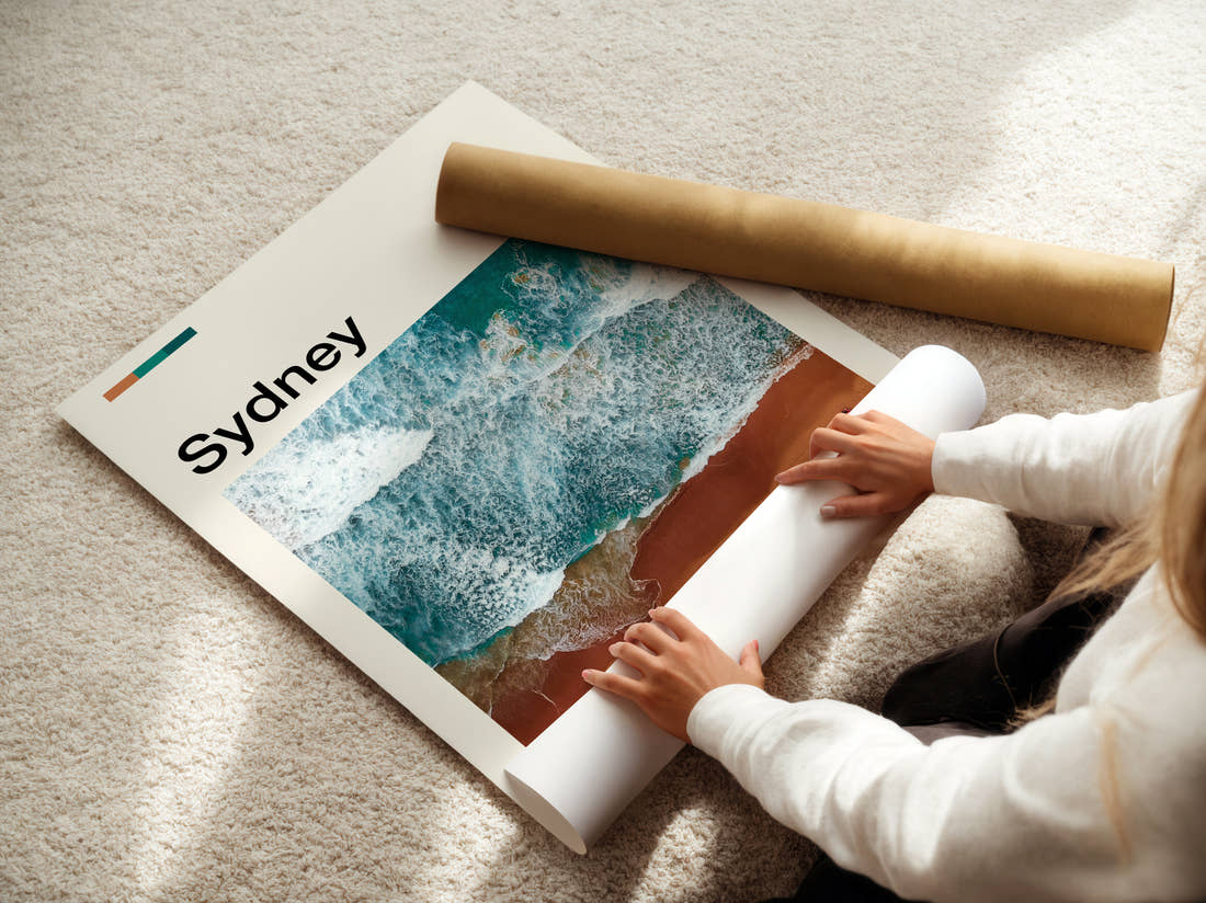 Sydney Aerial Waves On Sand Travel Print being unrolled from its postal tube