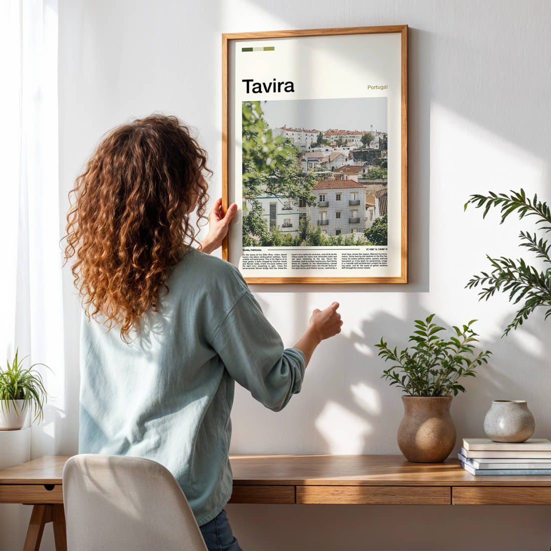 Tavira Whitewashed Hillside Town Travel Print framed on a pale wall beside houseplants