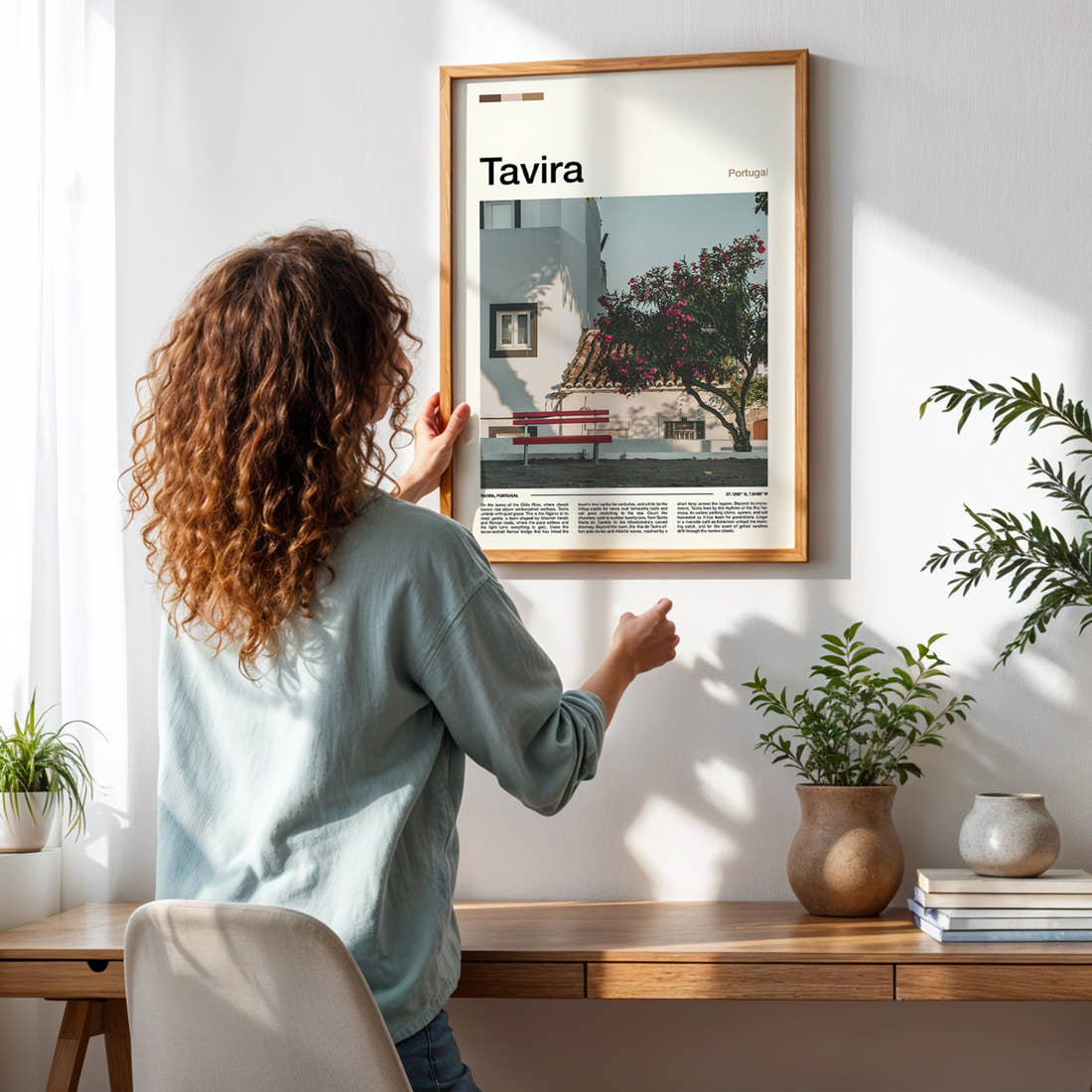 Tavira Whitewashed Courtyard Corner Travel Print framed on a pale wall beside houseplants