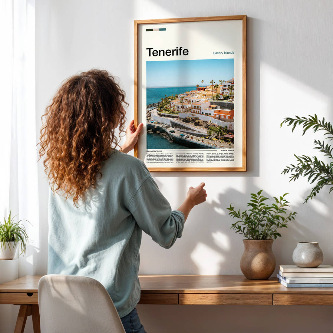 Tenerife Coastal Village View Travel Print framed on a pale wall beside houseplants