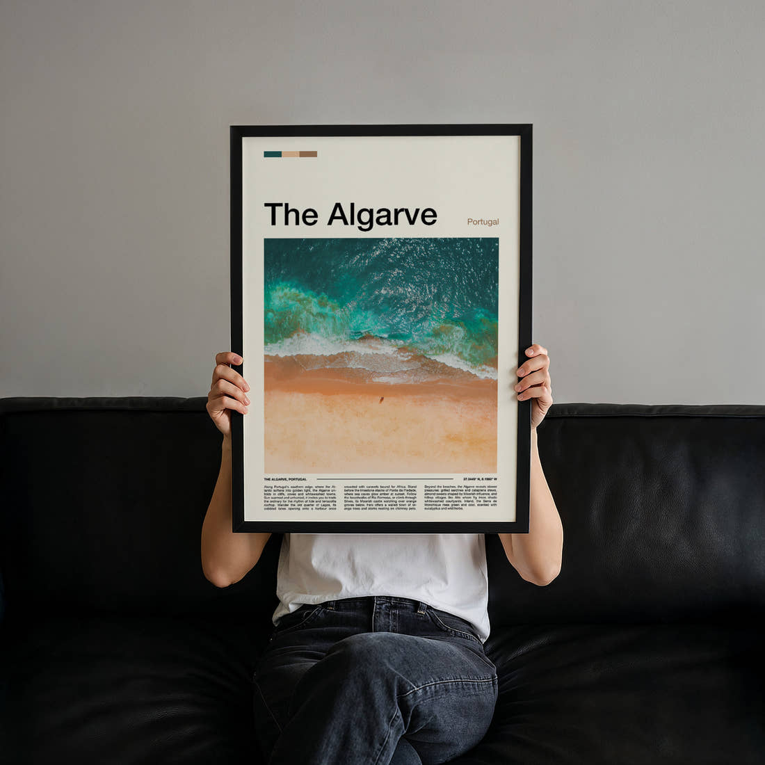 The Algarve Aerial Coastal Waves Travel Print held up by hand to show the size of the print