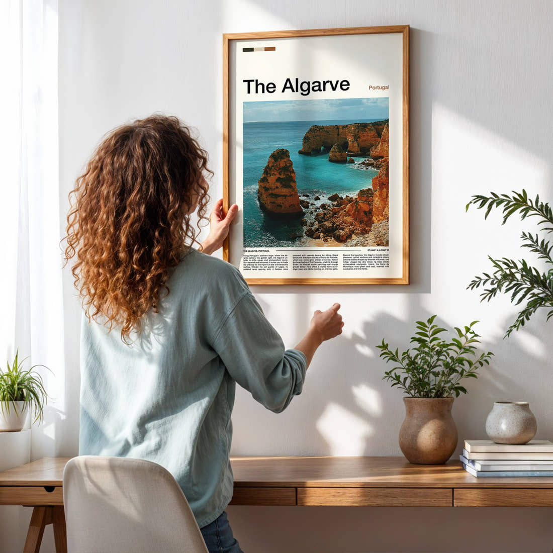 The Algarve Limestone Sea Cliffs Travel Print framed on a pale wall beside houseplants